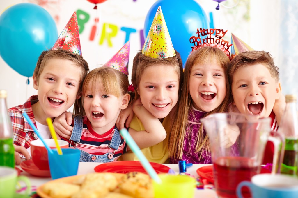 Group of adorable kids looking at camera at birthday party